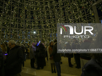 People are inside the Christmas lights at Praca do Comercio in Lisbon, Portugal, on December 14, 2024. The Christmas lights in Lisbon are of...