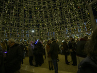 People are inside the Christmas lights at Praca do Comercio in Lisbon, Portugal, on December 14, 2024. The Christmas lights in Lisbon are of...