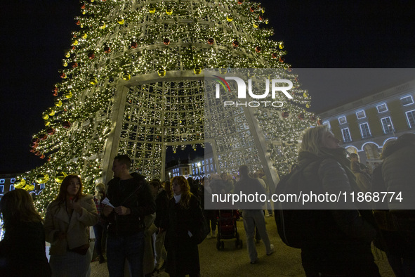 People are inside the Christmas lights at Praca do Comercio in Lisbon, Portugal, on December 14, 2024. The Christmas lights in Lisbon are of...