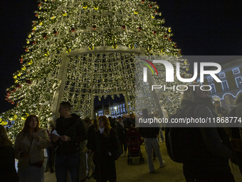 People are inside the Christmas lights at Praca do Comercio in Lisbon, Portugal, on December 14, 2024. The Christmas lights in Lisbon are of...