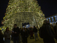 People are inside the Christmas lights at Praca do Comercio in Lisbon, Portugal, on December 14, 2024. The Christmas lights in Lisbon are of...