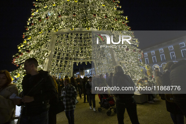 People are inside the Christmas lights at Praca do Comercio in Lisbon, Portugal, on December 14, 2024. The Christmas lights in Lisbon are of...