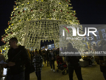 People are inside the Christmas lights at Praca do Comercio in Lisbon, Portugal, on December 14, 2024. The Christmas lights in Lisbon are of...