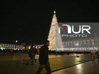 People gather around the Christmas lights at Praca do Comercio in Lisbon, Portugal, on December 14, 2024. The Christmas lights in Lisbon are...