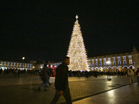 People gather around the Christmas lights at Praca do Comercio in Lisbon, Portugal, on December 14, 2024. The Christmas lights in Lisbon are...