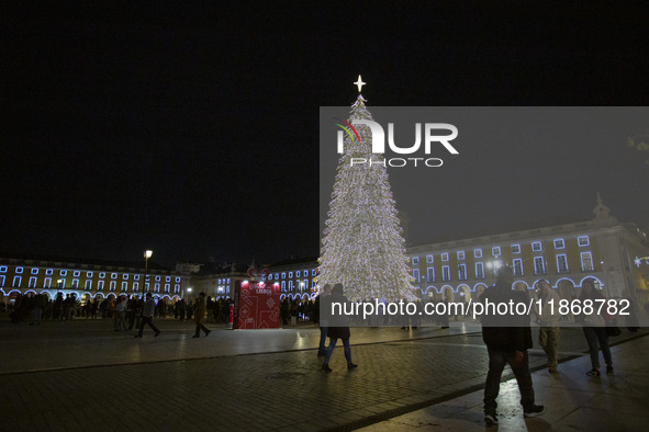 People gather around the Christmas lights at Praca do Comercio in Lisbon, Portugal, on December 14, 2024. The Christmas lights in Lisbon are...