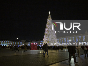 People gather around the Christmas lights at Praca do Comercio in Lisbon, Portugal, on December 14, 2024. The Christmas lights in Lisbon are...