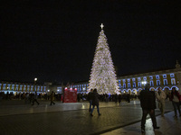 People gather around the Christmas lights at Praca do Comercio in Lisbon, Portugal, on December 14, 2024. The Christmas lights in Lisbon are...