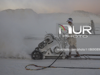 Labourers work at the ''White Mountain'' limestone extraction quarry site near Minya, Egypt, on December 14, 2024. Covered in fine white dus...