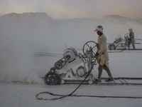 Labourers work at the ''White Mountain'' limestone extraction quarry site near Minya, Egypt, on December 14, 2024. Covered in fine white dus...