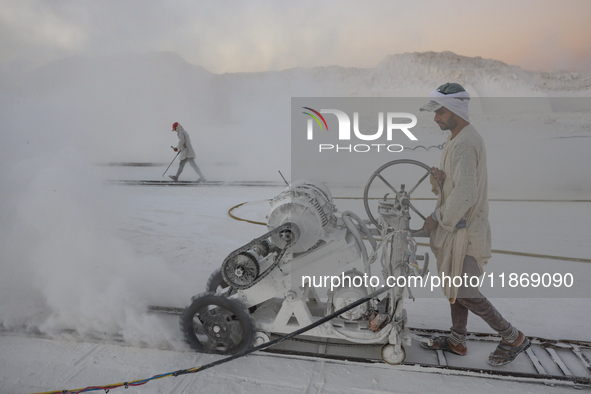 Labourers work at the ''White Mountain'' limestone extraction quarry site near Minya, Egypt, on December 14, 2024. Covered in fine white dus...