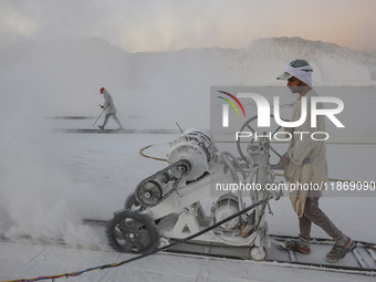 Labourers work at the ''White Mountain'' limestone extraction quarry site near Minya, Egypt, on December 14, 2024. Covered in fine white dus...