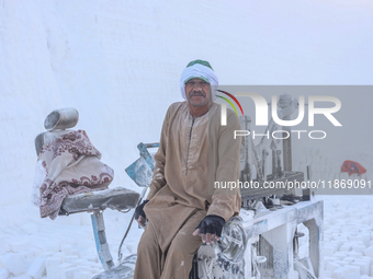 Labourers work at the ''White Mountain'' limestone extraction quarry site near Minya, Egypt, on December 14, 2024. Covered in fine white dus...