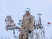 Labourers work at the ''White Mountain'' limestone extraction quarry site near Minya, Egypt, on December 14, 2024. Covered in fine white dus...