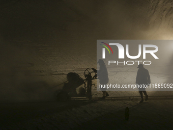 Labourers work at the ''White Mountain'' limestone extraction quarry site near Minya, Egypt, on December 14, 2024. Covered in fine white dus...