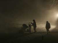 Labourers work at the ''White Mountain'' limestone extraction quarry site near Minya, Egypt, on December 14, 2024. Covered in fine white dus...