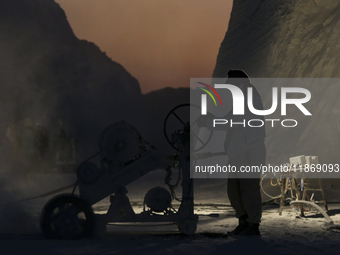 Labourers work at the ''White Mountain'' limestone extraction quarry site near Minya, Egypt, on December 14, 2024. Covered in fine white dus...