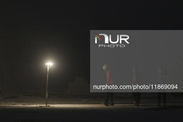 Labourers work at the ''White Mountain'' limestone extraction quarry site near Minya, Egypt, on December 14, 2024. Covered in fine white dus...