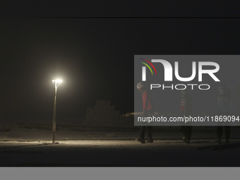 Labourers work at the ''White Mountain'' limestone extraction quarry site near Minya, Egypt, on December 14, 2024. Covered in fine white dus...