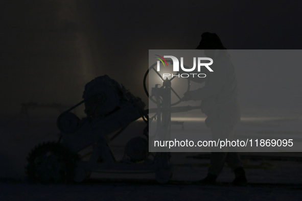 Labourers work at the ''White Mountain'' limestone extraction quarry site near Minya, Egypt, on December 14, 2024. Covered in fine white dus...