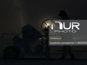 Labourers work at the ''White Mountain'' limestone extraction quarry site near Minya, Egypt, on December 14, 2024. Covered in fine white dus...