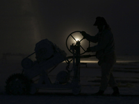 Labourers work at the ''White Mountain'' limestone extraction quarry site near Minya, Egypt, on December 14, 2024. Covered in fine white dus...