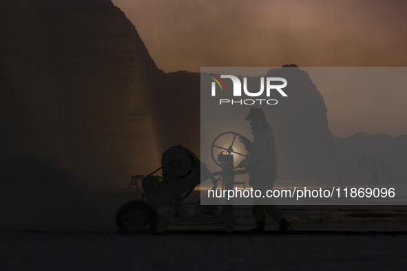 Labourers work at the ''White Mountain'' limestone extraction quarry site near Minya, Egypt, on December 14, 2024. Covered in fine white dus...