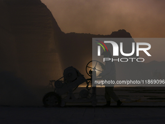 Labourers work at the ''White Mountain'' limestone extraction quarry site near Minya, Egypt, on December 14, 2024. Covered in fine white dus...