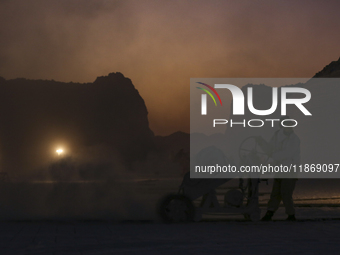 Labourers work at the ''White Mountain'' limestone extraction quarry site near Minya, Egypt, on December 14, 2024. Covered in fine white dus...