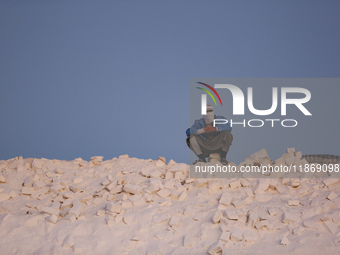 Labourers work at the ''White Mountain'' limestone extraction quarry site near Minya, Egypt, on December 14, 2024. Covered in fine white dus...