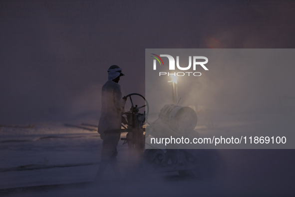 Labourers work at the ''White Mountain'' limestone extraction quarry site near Minya, Egypt, on December 14, 2024. Covered in fine white dus...