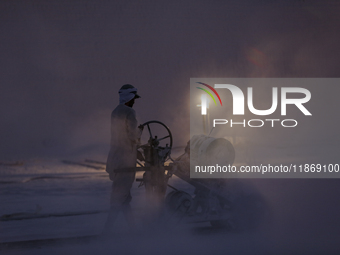 Labourers work at the ''White Mountain'' limestone extraction quarry site near Minya, Egypt, on December 14, 2024. Covered in fine white dus...