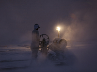 Labourers work at the ''White Mountain'' limestone extraction quarry site near Minya, Egypt, on December 14, 2024. Covered in fine white dus...