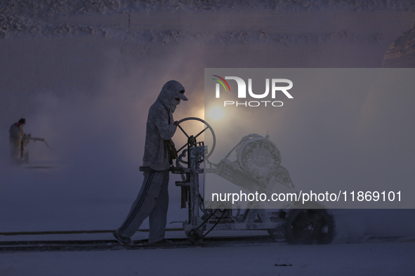 Labourers work at the ''White Mountain'' limestone extraction quarry site near Minya, Egypt, on December 14, 2024. Covered in fine white dus...