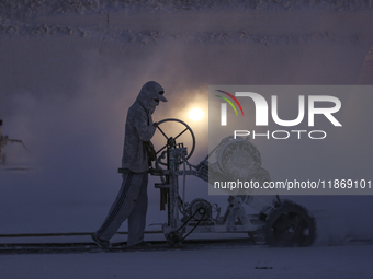 Labourers work at the ''White Mountain'' limestone extraction quarry site near Minya, Egypt, on December 14, 2024. Covered in fine white dus...