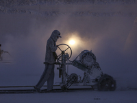 Labourers work at the ''White Mountain'' limestone extraction quarry site near Minya, Egypt, on December 14, 2024. Covered in fine white dus...