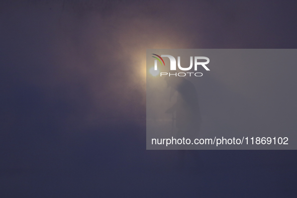 Labourers work at the ''White Mountain'' limestone extraction quarry site near Minya, Egypt, on December 14, 2024. Covered in fine white dus...