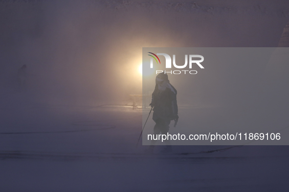 Labourers work at the ''White Mountain'' limestone extraction quarry site near Minya, Egypt, on December 14, 2024. Covered in fine white dus...