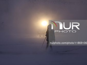 Labourers work at the ''White Mountain'' limestone extraction quarry site near Minya, Egypt, on December 14, 2024. Covered in fine white dus...