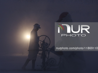 Labourers work at the ''White Mountain'' limestone extraction quarry site near Minya, Egypt, on December 14, 2024. Covered in fine white dus...