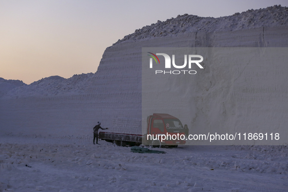 Labourers work at the ''White Mountain'' limestone extraction quarry site near Minya, Egypt, on December 14, 2024. Covered in fine white dus...