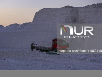 Labourers work at the ''White Mountain'' limestone extraction quarry site near Minya, Egypt, on December 14, 2024. Covered in fine white dus...