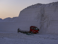 Labourers work at the ''White Mountain'' limestone extraction quarry site near Minya, Egypt, on December 14, 2024. Covered in fine white dus...