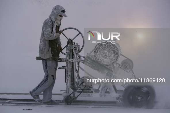 Labourers work at the ''White Mountain'' limestone extraction quarry site near Minya, Egypt, on December 14, 2024. Covered in fine white dus...