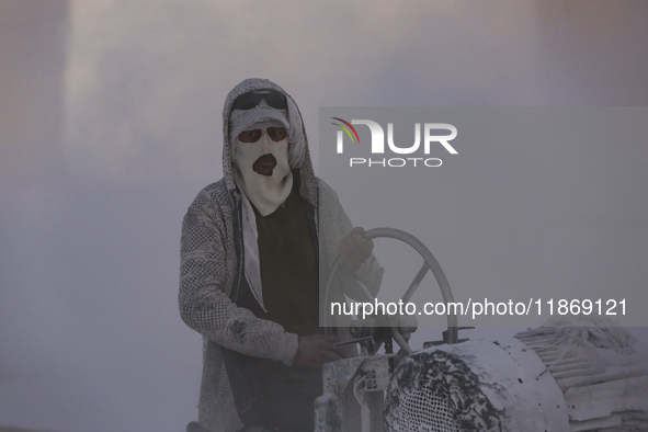 Labourers work at the ''White Mountain'' limestone extraction quarry site near Minya, Egypt, on December 14, 2024. Covered in fine white dus...