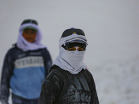 Labourers work at the ''White Mountain'' limestone extraction quarry site near Minya, Egypt, on December 14, 2024. Covered in fine white dus...