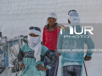 Labourers work at the ''White Mountain'' limestone extraction quarry site near Minya, Egypt, on December 14, 2024. Covered in fine white dus...