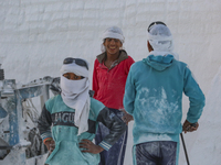 Labourers work at the ''White Mountain'' limestone extraction quarry site near Minya, Egypt, on December 14, 2024. Covered in fine white dus...