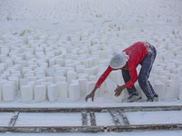 Labourers work at the ''White Mountain'' limestone extraction quarry site near Minya, Egypt, on December 14, 2024. Covered in fine white dus...