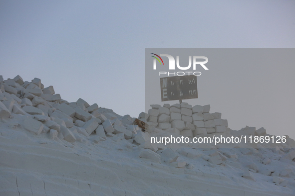 Labourers work at the ''White Mountain'' limestone extraction quarry site near Minya, Egypt, on December 14, 2024. Covered in fine white dus...